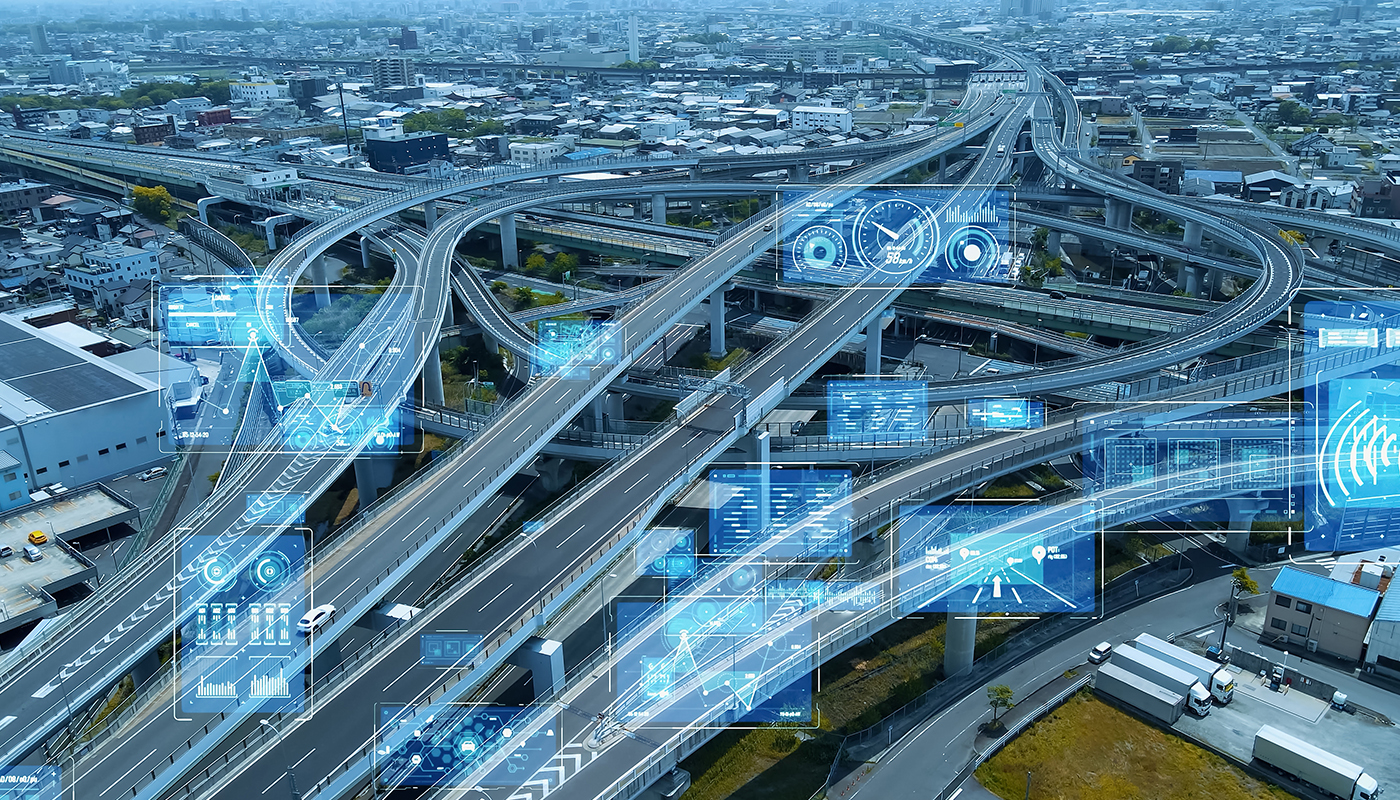 Looking down on a highway system of interchanges taken from 1,000 feet above with TMS data glowing above different points in the highway system