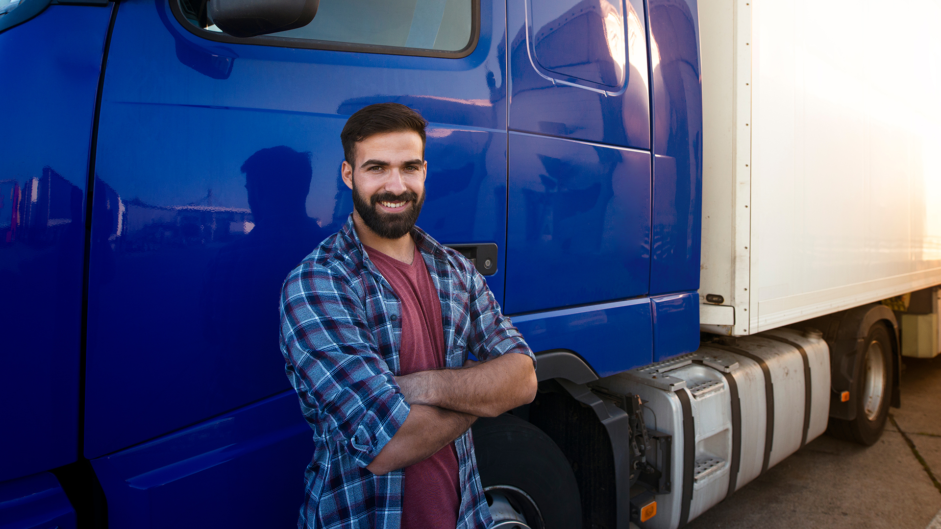A semi truck driver outside his truck