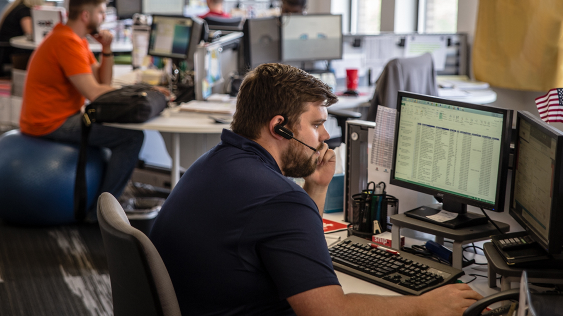 Spot TMS employee hard at work looking at TMS data on multiple computer screens