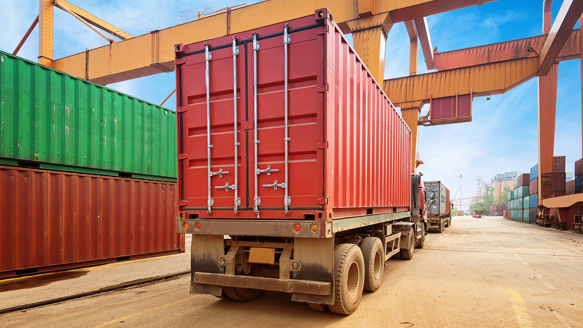 semi truck in a port authority area after getting loaded with cargo - intermodal at work