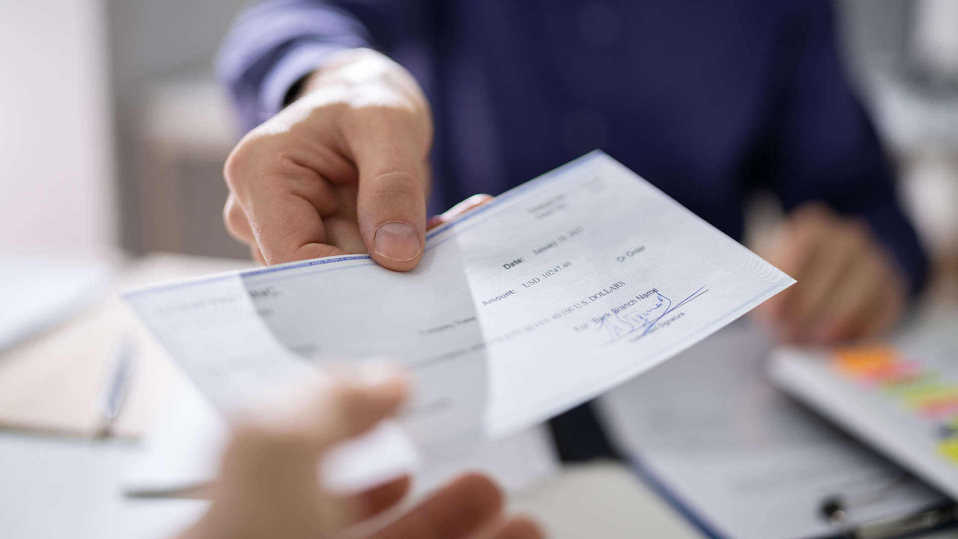 A hand giving a paper Accessorial Request to another person's hand