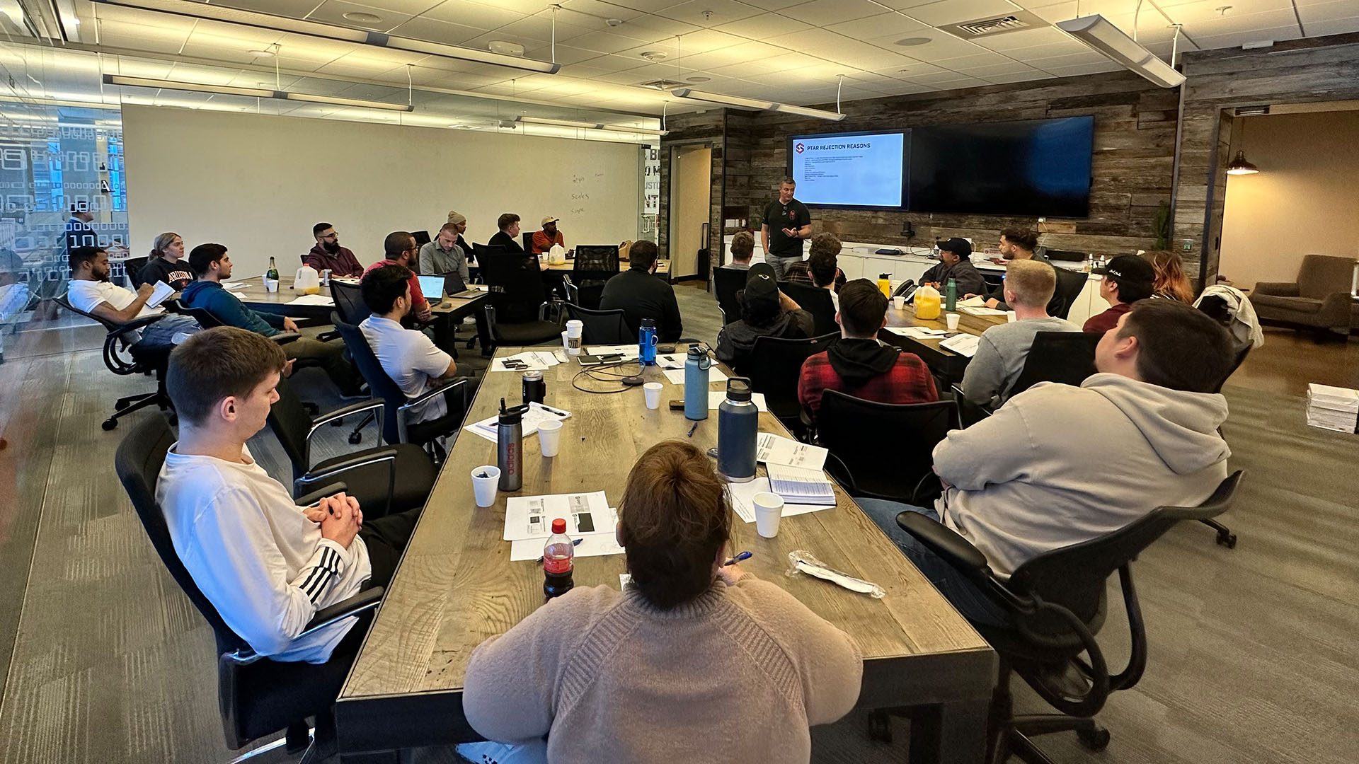 Spot employees hosting a seminar of shipping and trucking TMS applications and software solutions