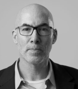 Black and white headshot of New York Times reporter Peter S. Goodman